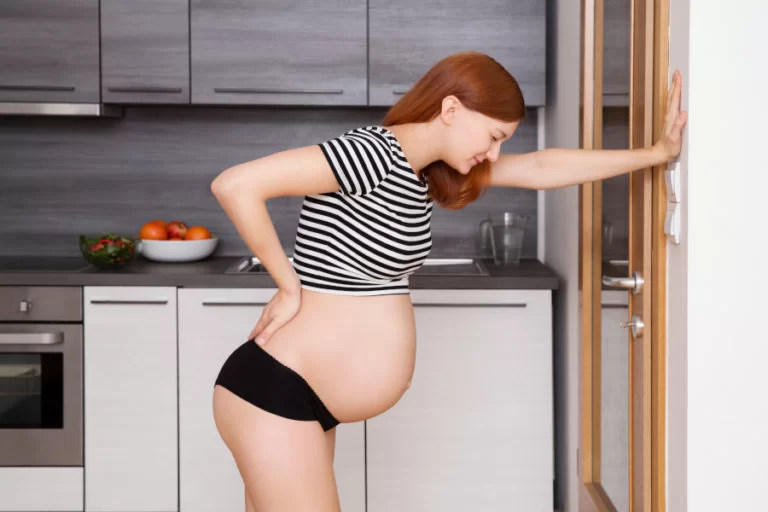 A pregnant woman resting during back pain